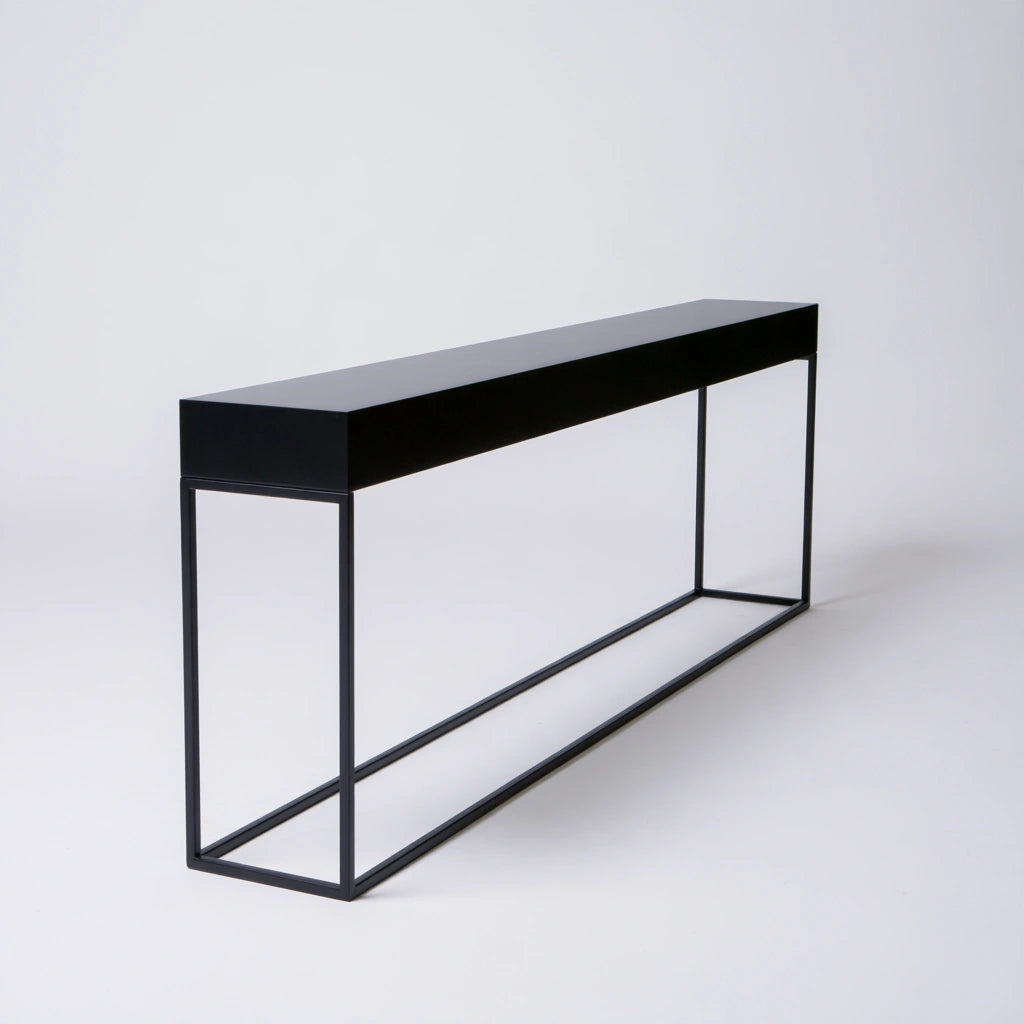 Minimalist black hall console table by coatandcatchall, showcasing a sleek, modern design from a three-quarter angle.