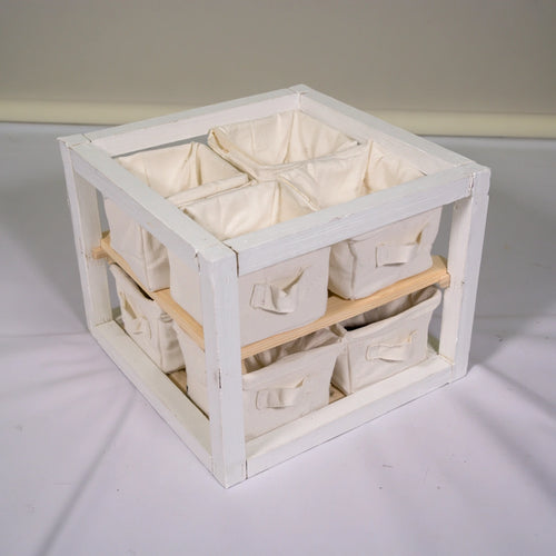 White wooden children's storage unit from coatandcatchall, minimalist children's furniture for organized playroom or bedroom storage.